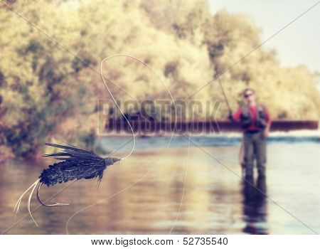  a person fly fishing in a river with a fly in the foreground vintage toned 