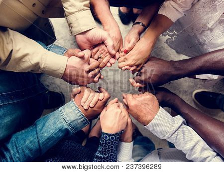 Group of diverse hands holding each other support together teamwork aerial view