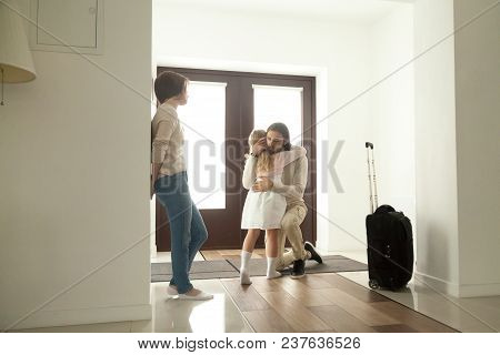 Little Kid Girl Embracing Dad Leaving Family Moving Out With Travel Case, Sad Daughter Hugging Fathe