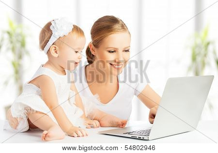 Mom And Baby With Computer Working From Home