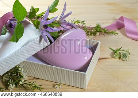 Lavender Purple Heard Shape From Glass In An Open Gift Box And Some Flowers O A Wooden Table, Love S