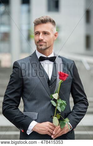 Special Occasion Formalwear. Smiling Man With Rose For Special Occasion. Tuxedo Man Outdoor