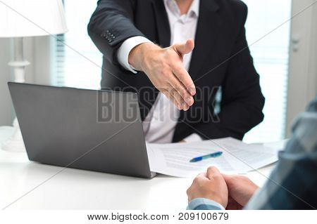 Business man offer and give hand for handshake in office. Successful job interview. Apply for loan in bank. Salesman, bank worker or lawyer shake for deal, agreement or sale. Increase of salary.