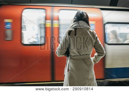 London, Uk - March 16, 2019: Rear View Of A Woman Standing On A London Underground Station Platform,