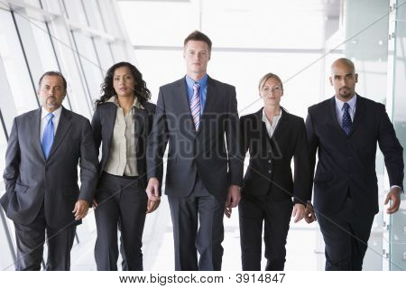 Middle Eastern / Western Business People Walking Down Corridor