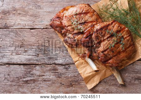 Grilled Pork With Herbs On An Old Table Top View Close-up