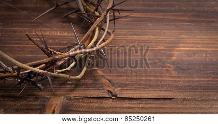 A crown on thorns, a religious symbol on a wooden background - Easter background