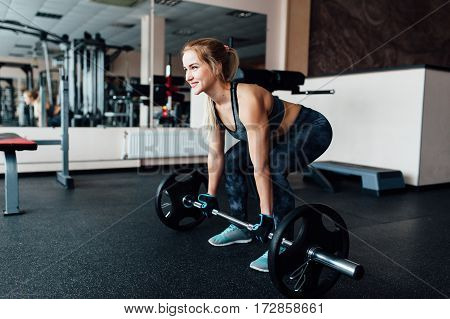 Beautiful Fitness Woman Lifting Barbell.