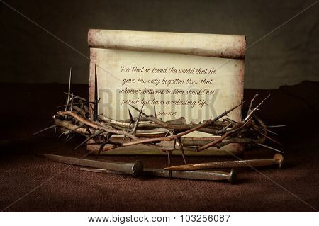 Bible Scripture with crown of thorns and nails over cloth - John 3:16