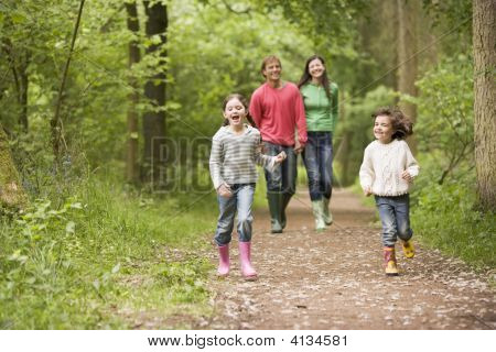 Families Walking On Path Holding Hands Smiling