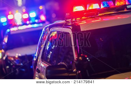 Night Time Police Violent Crime Intervention. Police Vehicles with Flashing Lights.