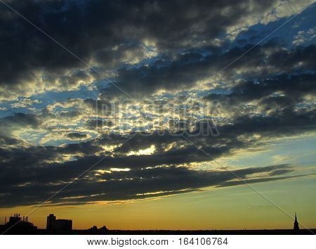 Beautiful strato-cumulus sunset with silhouettes of buildings and a church steeple