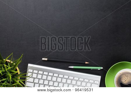 Office leather desk table with computer, flower and coffee cup. Top view with copy space