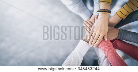 Close Up Top View Of Young Business People Putting Their Hands Together. Stack Of Hands. Unity And T