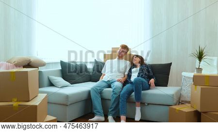 Caucasian Joyful Boyfriend And Girlfriend Moving In Together In New House. Tired Happy Young Married