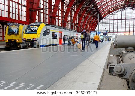 Antwerp, Belgium, May 2019,  Rear View Of People Waiting And Walking Towards Metro Train At Antwerp 