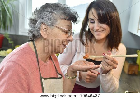 Homecare cooking dinner for elderly woman