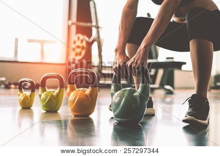 Close Up Of Woman Lifting Kettlebell Like Dumbbells In Fitness Sport Club Gym Training Center With S