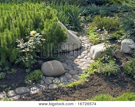 Green garden with paved path.