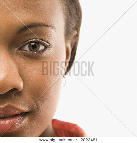 Close up portrait of African American woman against white background.