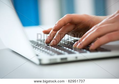 Closeup of businesswoman typing on laptop computer