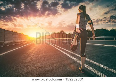 stretching run runner road jogging clothes flare sunset street fitness cross sunbeam success running sportswear - stock image