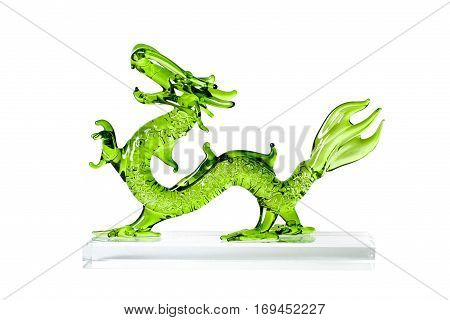 Glass green traditional chinese dragon isolated on white background. Feng Shui statuette.