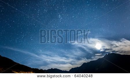 night sky stars and moon across mountain