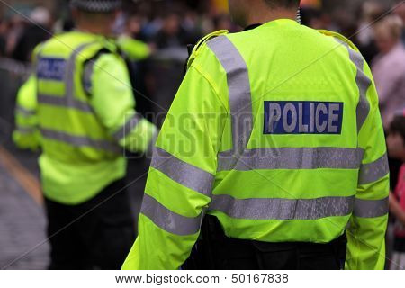 Police in hi-visibility jackets policing crowd control at a UK event