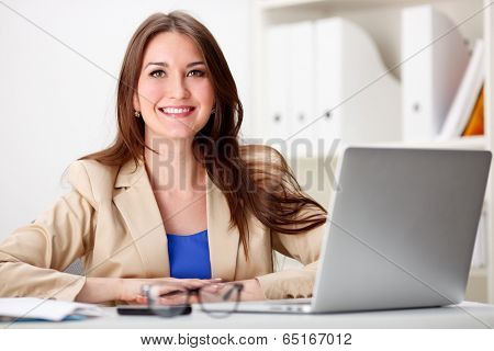 Business woman working on laptop computer at office