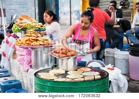 GUATEMALA CITY, GUATEMALA-DEC 25, 2015: Mayan women sell   Guatemalan food  at the street of Guatemala city on Dec 25 2015. Guatemala. 