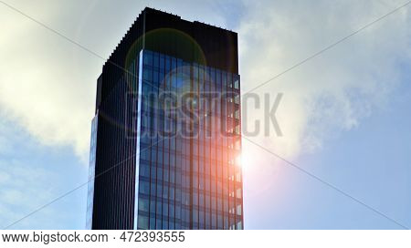 Looking Up At The Commercial Buildings In Downtown. Modern Office Building Against Blue Sky. Windows