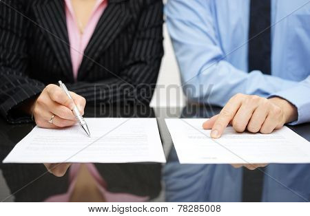 Businessman And Businesswoman Are Inspecting  Contract