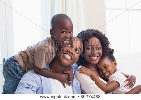 Happy family posing on the couch together at home in the living room