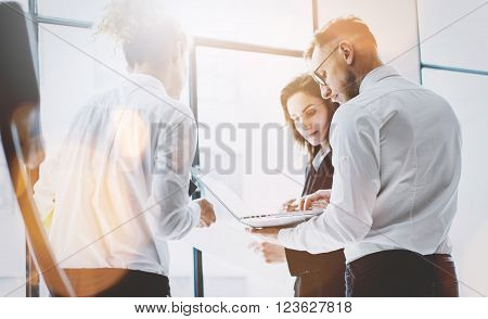 Business team work process. Photo professional crew working with new startup project. Project managers meeting. Analyze business plans laptop. Blurred background, film effect, bokeh.