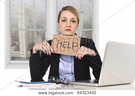 Young Stressed Businesswoman Holding Help Sign Overworked At Office Computer