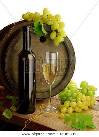 White wine, grapes and old barrel on white background