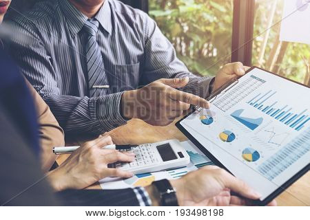 Co working conference Business team meeting present investor colleagues discussing new plan financial graph data on office table with laptop and digital tablet Finance accounting investment.