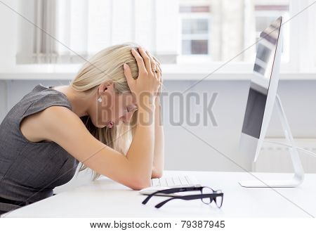 Overworked woman in front of computer