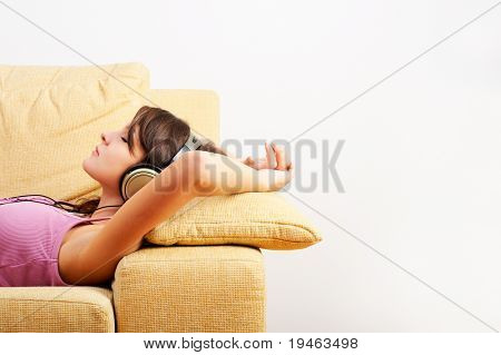 Young Girl enjoys listening music in headphones