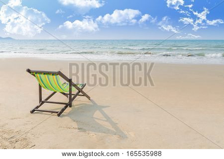 Beach chair on the sand with summer Summer background. Summer fresh concept. Lonely in summer beach. Selective focus on chair.