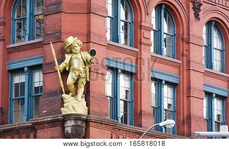 New York, USA, november 2016: a golden puck statuette by Henry Baerer decorating the puck building on lower manhattan