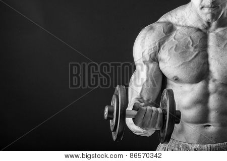 Man makes exercises dumbbells.