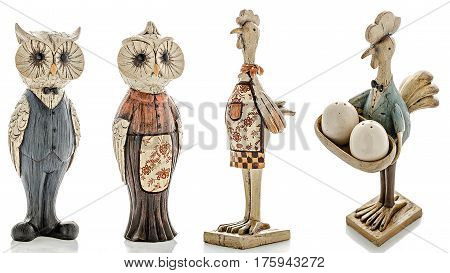 Wooden figurines, wooden statuette of an owl and wooden statuette of a chicken, isolated white background