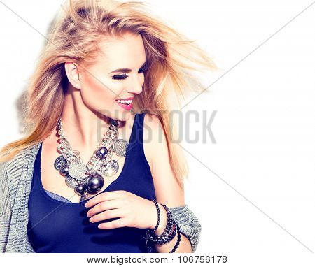 Fashion model girl portrait casual dressed, modern accessories - necklace and bracelets. Beauty young smiling woman, Blowing blond hair, fashion make up. Street fashion, urban style. Isolated on white