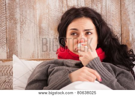 Young sick girl lying in bed