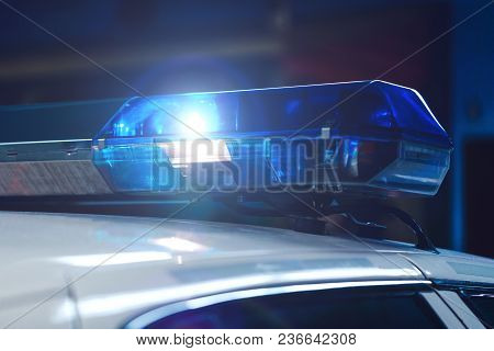 Police At Night In The Car With Blue Siren Flasher. Siren On Police Car Flashing, Close-up. Police L