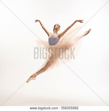 Graceful Classic Ballerina Dancing, Posing Isolated On White Studio Background. Tender Peach Cloth. 