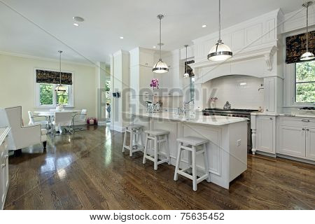 Large kitchen in luxury home with white cabinetry