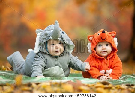 Two baby boys dressed in animal costumes